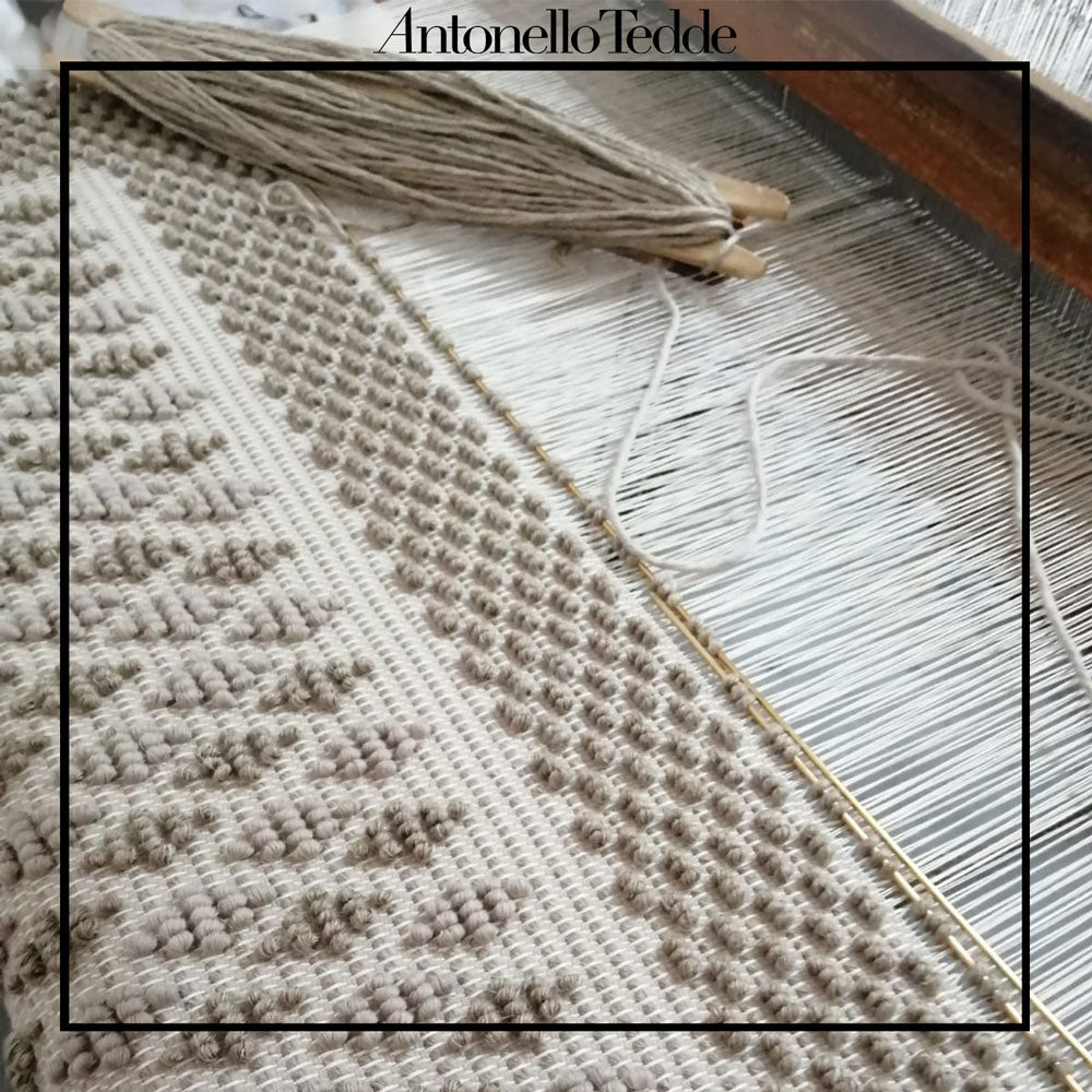 The wooden loom where Antonello Tedde Celvia Medium Tote Bag is handwoven, a reimagined classic that marks the return of the beloved rombetti (Multiple Diamonds) pattern in a fresh, contemporary silhouette