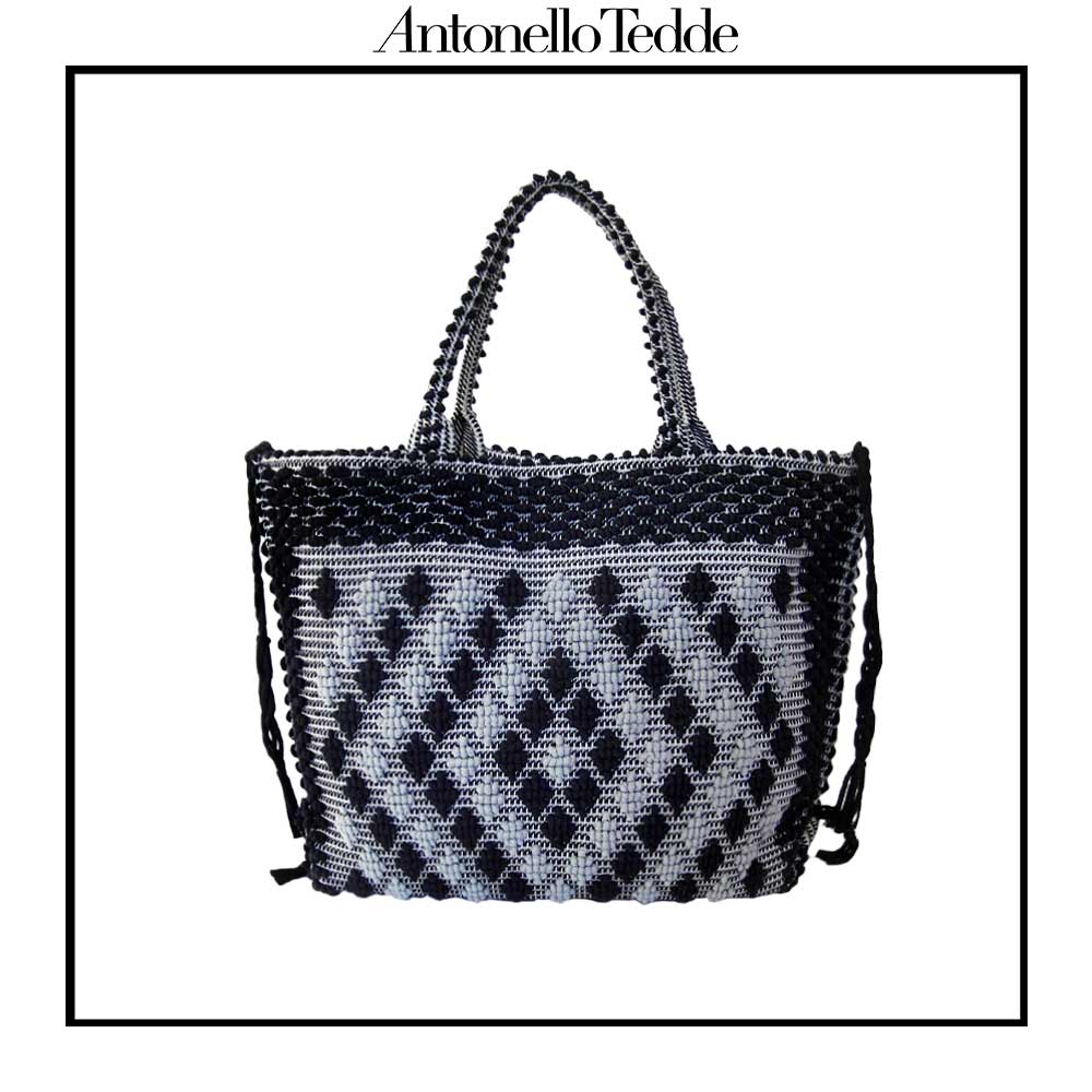 Sustainable black and grey tote bag featuring a unique pattern of small diamonds forming a larger diamond, crafted using authentic Sardinian hand-weaving techniques in ethically managed factories. This eco-conscious tote bag combines contemporary design with traditional craftsmanship, offering a stylish accessory that embodies sustainability and cultural heritage.