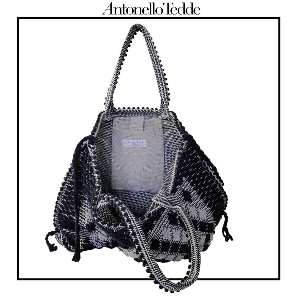 INSIDE with POCKET VIEW of Sustainable black and grey tote bag featuring a unique pattern of small diamonds forming a larger diamond, crafted using authentic Sardinian hand-weaving techniques in ethically managed factories. This eco-conscious tote bag combines contemporary design with traditional craftsmanship, offering a stylish accessory that embodies sustainability and cultural heritage.