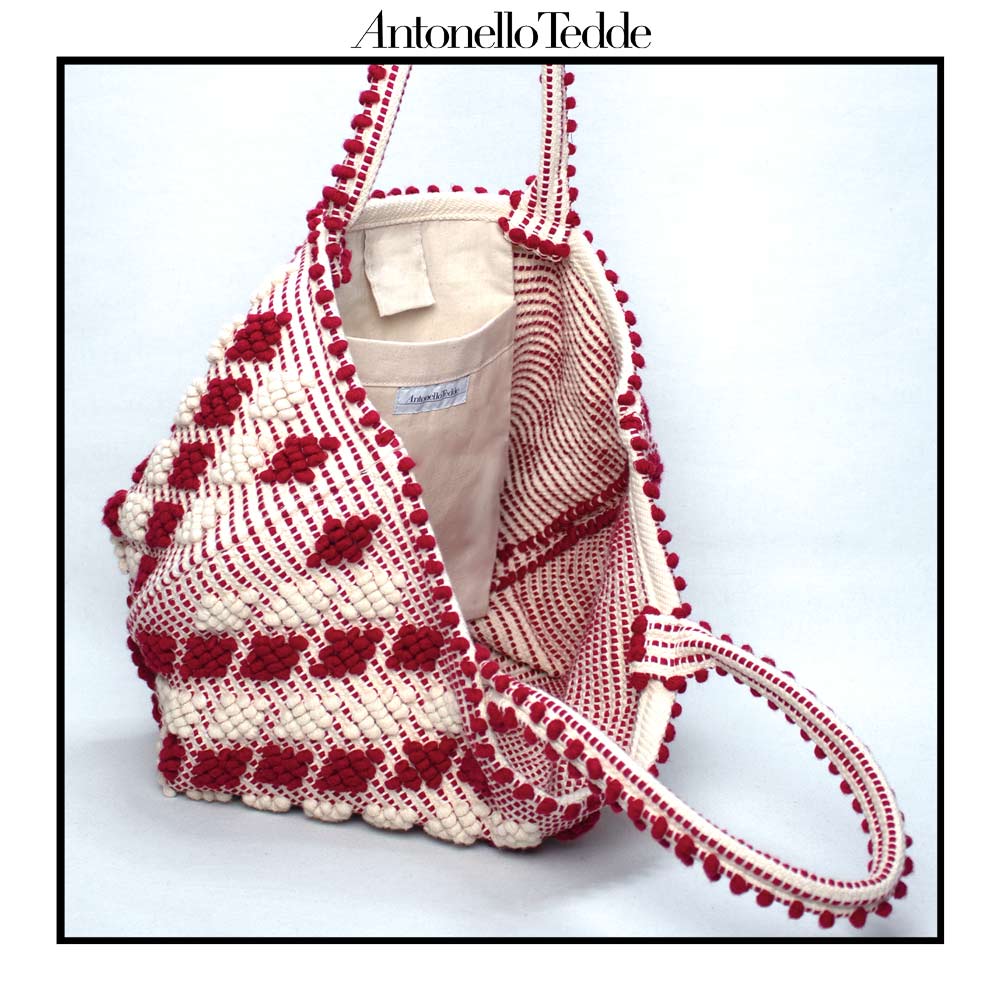 Internal view of Antonello Tedde red-and-white-patterned handbag on a white background. Celvia Medium Red and Cream Tote Bag is handwoven, a reimagined classic that marks the return of the beloved rombetti (Multiple Diamonds) pattern in a fresh, contemporary silhouette