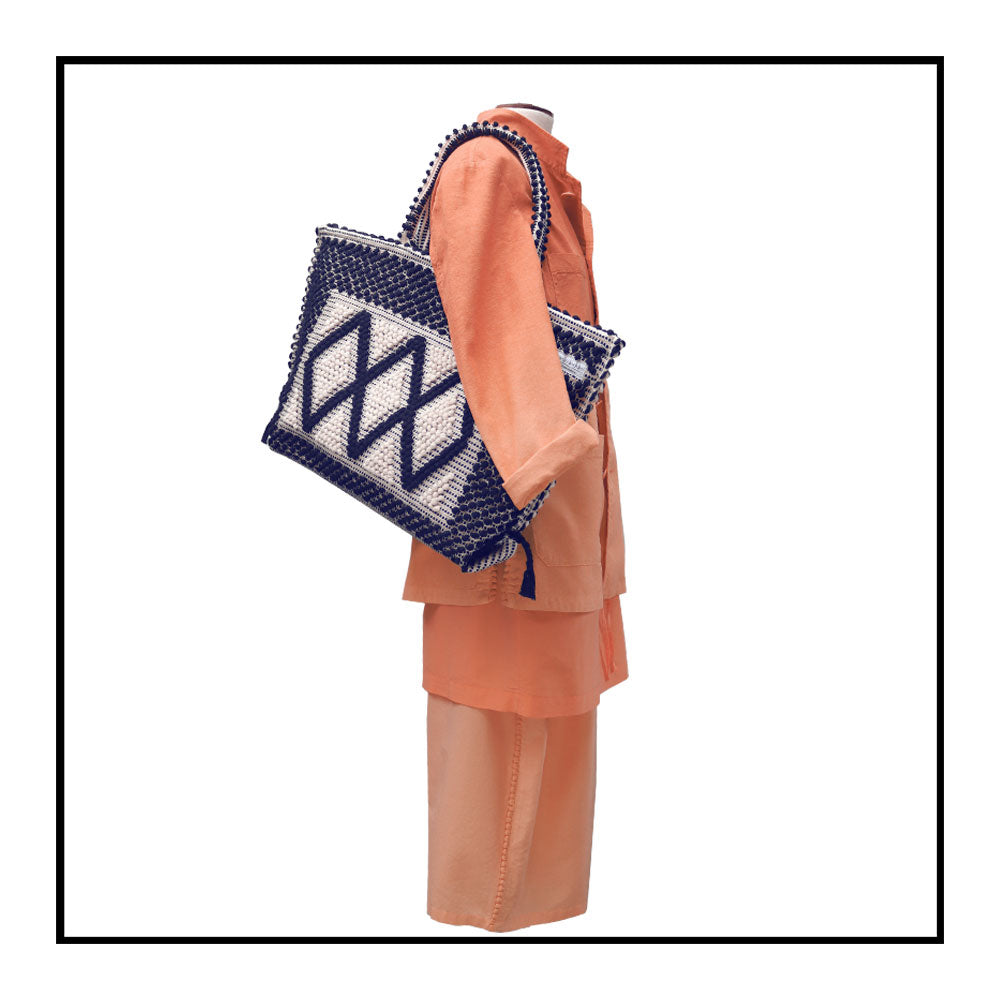 The handbag on a model - Sustainable tote - summer bag - luxury handbag - handwoven black and white tote made in Italy by hand • timeless individualistic fashion • eco-friendly fashion • socially responsible, lasting fashion.