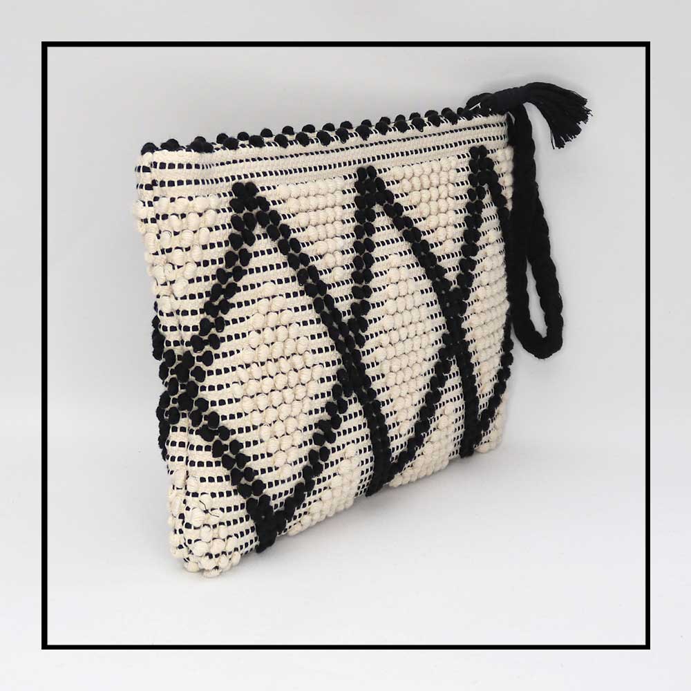 Side view of the handbag -piattina zip clutch bag in black and white Best eco luxury bags and accessories brand. Stylish clothes and Eco-Friendly with recycled yarns #luxury #ecoconcious #sustainablestyle #ethicalbrands #ecoliving #ecofashion #ecostyle #ethicalhandbags #handbags.