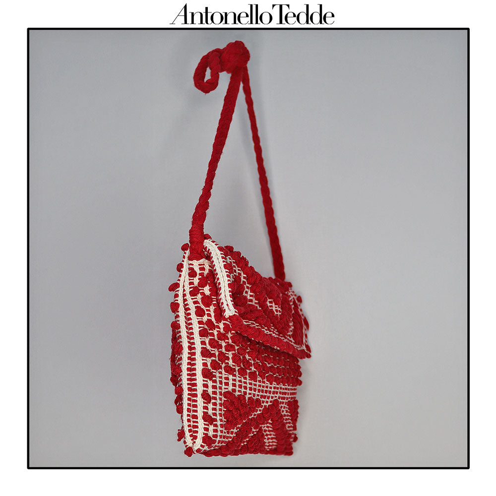 Side view of the Red and Cream ground beloved style within the Antonello Tedde collection, the Suni Rombi Clutch cross-body. The bag is celebrated for its effortless blend of elegance, function, and sustainable craftsmanship.