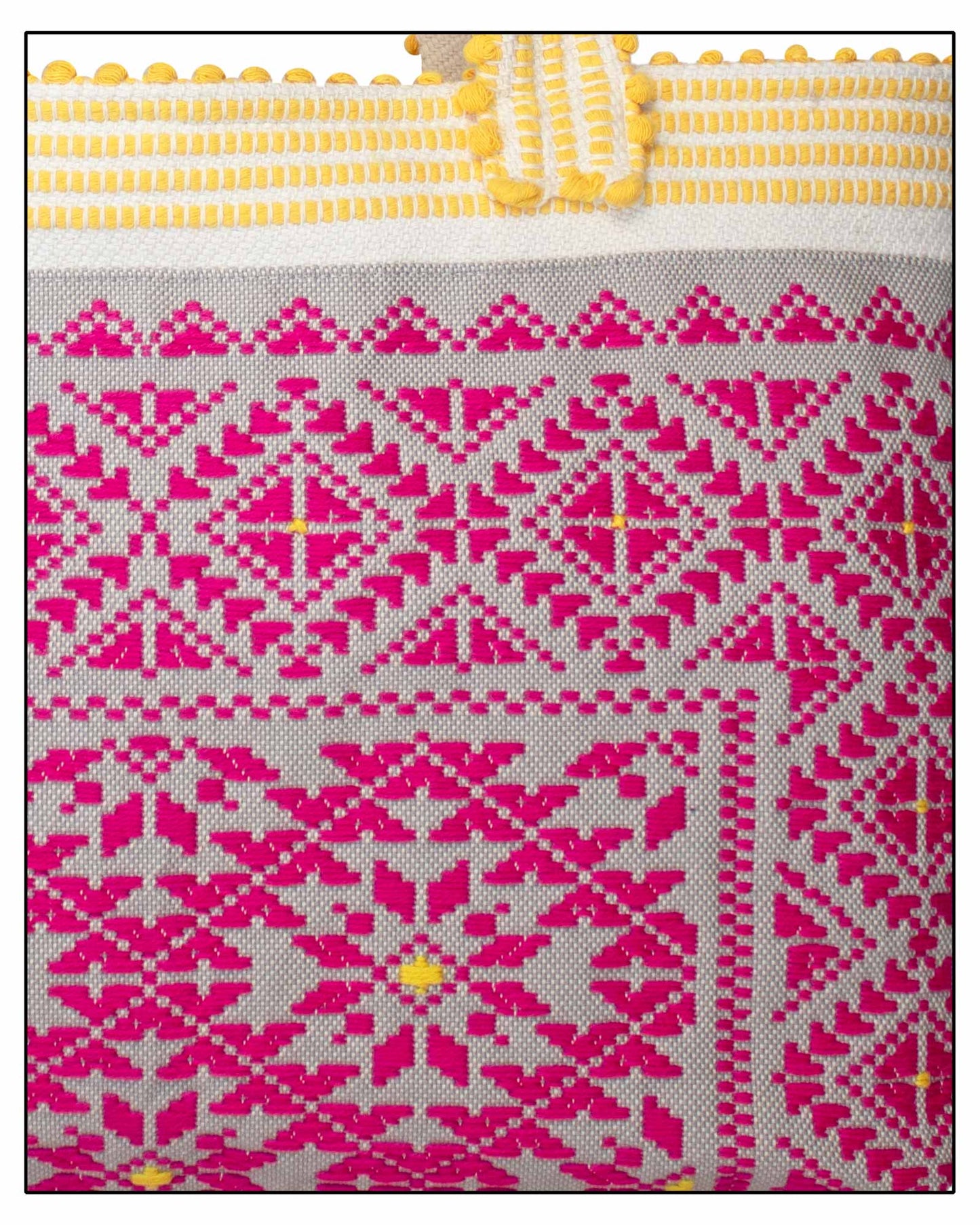Inside view - lining and pockets with label of an Antonello Tedde Capriccioli Medium Tote Bag is made, handwoven in Sardinia with fuchsia and grey jacquard pattern, yellow handles, and lined interior with pockets on a white background.