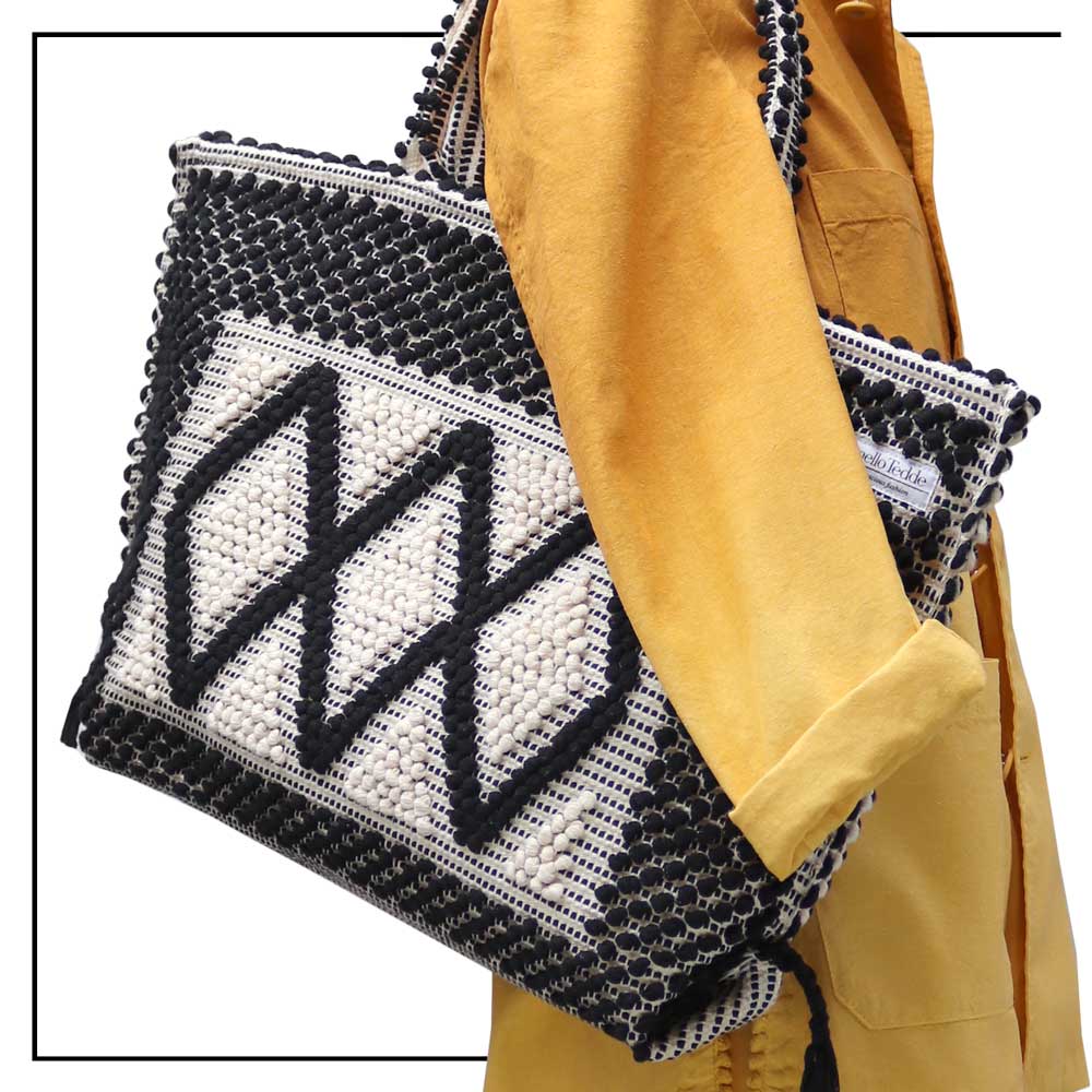 Detailed view the tote bag on the model - Sustainable tote - summer bag - luxury handbag - handwoven black and white tote made in Italy by hand • timeless individualistic fashion • eco-friendly fashion • socially responsible, lasting fashion.