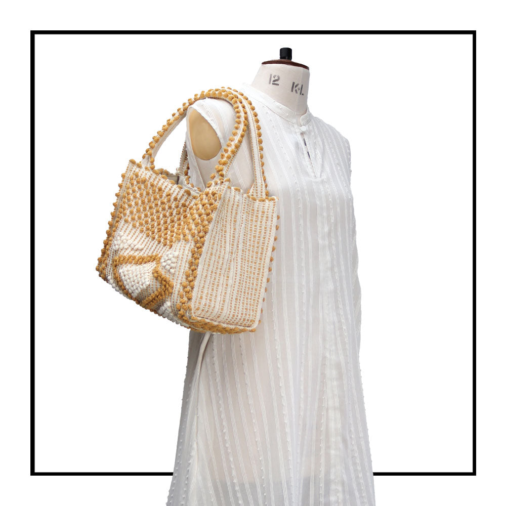 MONTE SANTU - HOBO BAG - on mannequin MUSTARD and CREAM linen handbag - Best eco luxury bags and accessories brand. Stylish clothes and Eco-Friendly with recycled yarns #luxury #ecoconcious #sustainablestyle #ethicalbrands #ecoliving #ecofashion #ecostyle #ethicalhandbags #handbags