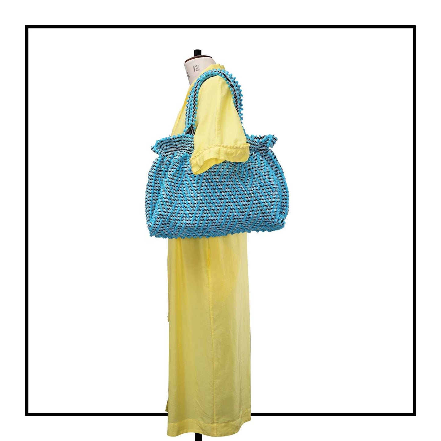 The handbag on a model - Sustainable tote - summer bag - luxury handbag - handwoven black and white tote made in Italy by hand • timeless individualistic fashion • eco-friendly fashion • socially responsible, lasting fashion.