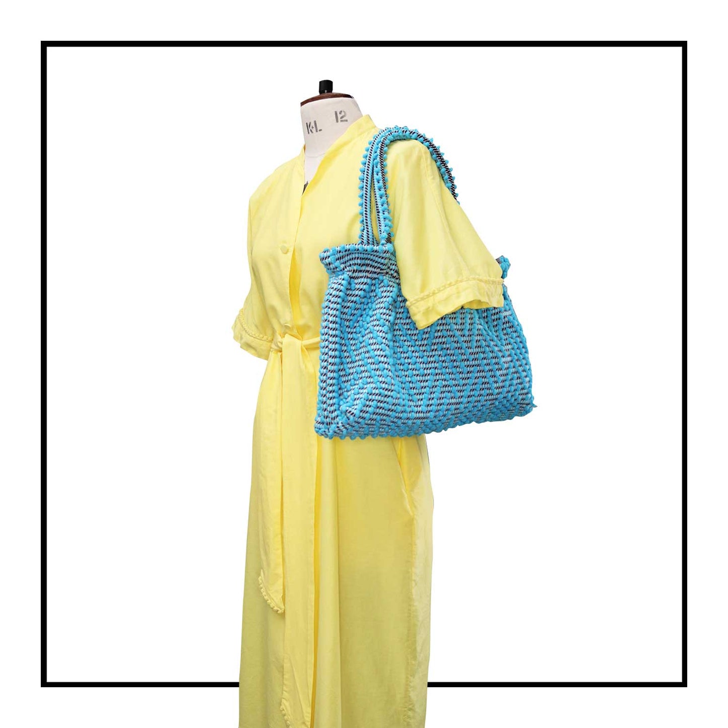 The handbag on a model - Sustainable tote - summer bag - luxury handbag - handwoven black and white tote made in Italy by hand • timeless individualistic fashion • eco-friendly fashion • socially responsible, lasting fashion.