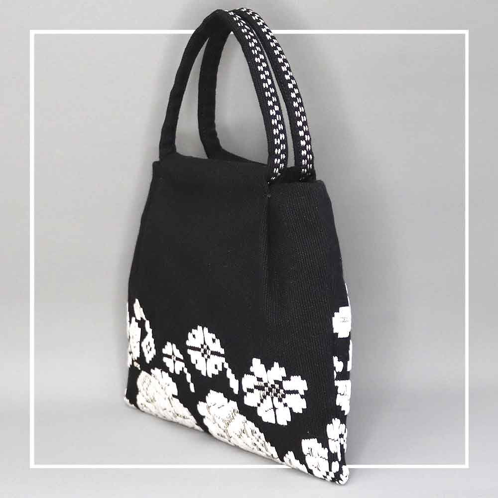 side view for black and white evening bag to complete your look with our selection of accessories crafted with the environment in mind