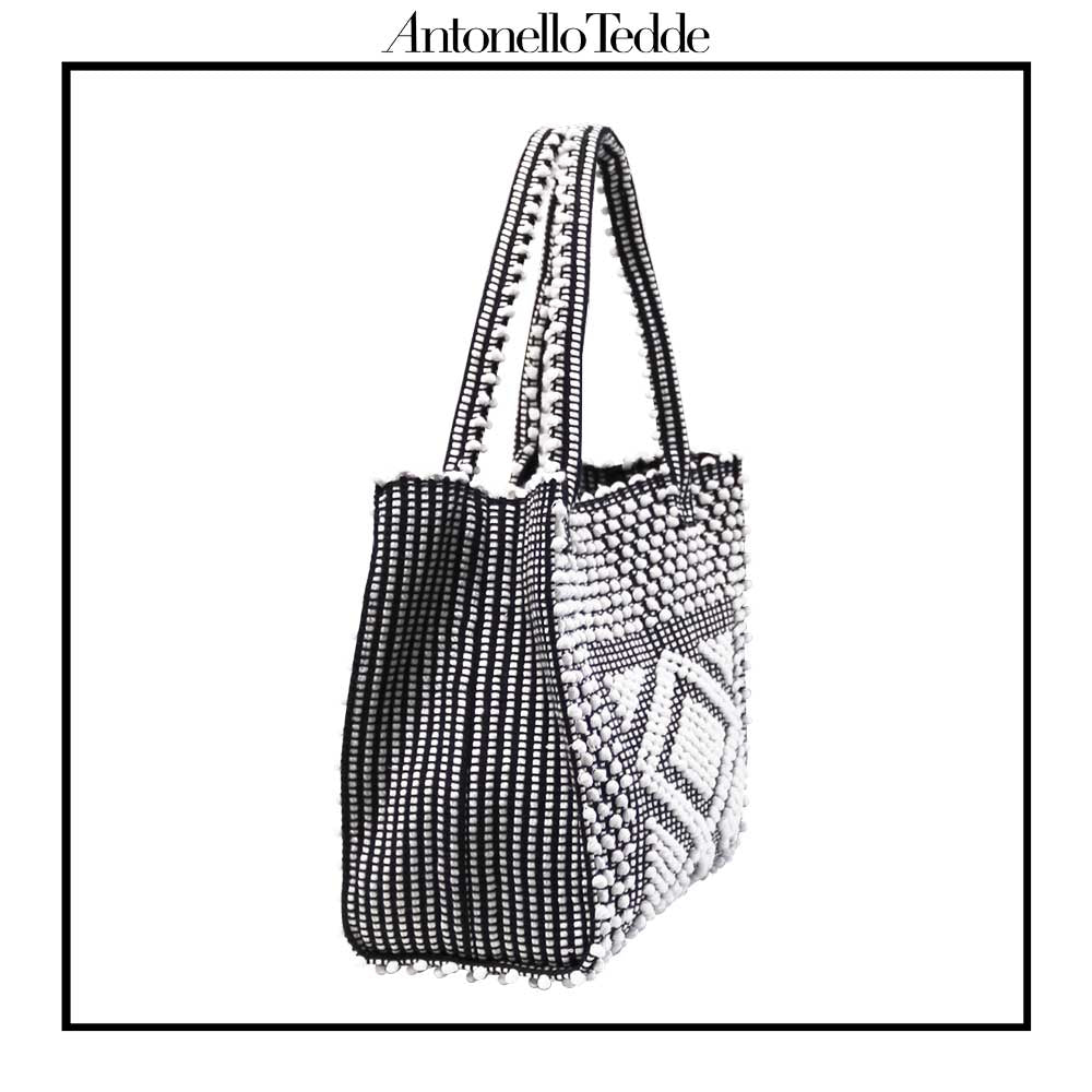 SIDE VIEW of the black and white tote bag. Sustainable tote - summer bag - luxury handbag - handwoven black and white tote made in Italy by hand • timeless individualistic fashion • eco-friendly fashion • socially responsible, lasting fashion