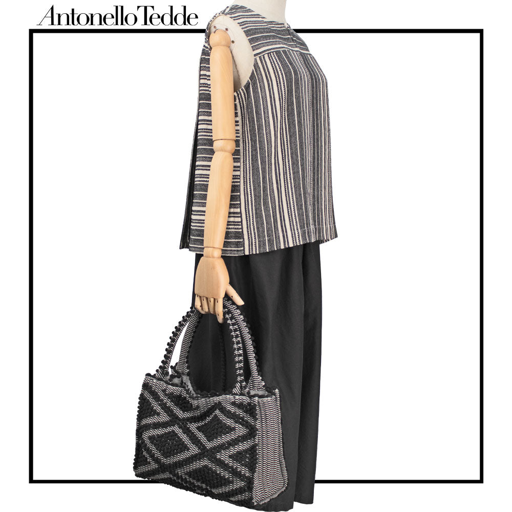 Structured artisan tote in black, styled for fall and winter fashion.