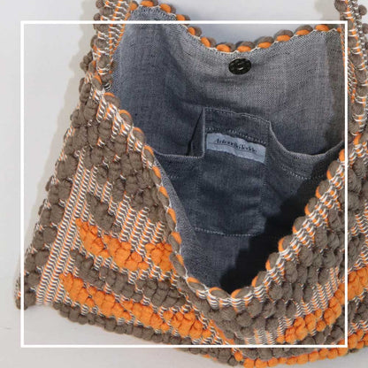 Lining view and branding of Quality eco-conscious hobo bag handwoven orange and taupe. Stylish clothes and Eco-Friendly with recycled yarns #luxury #ecoconcious #sustainablestyle  #ethicalbrands #ecoliving  #ecofashion #ecostyle #ethicalhandbags #handbags #sustainablelifestyle #ethicalfashion #sustainability