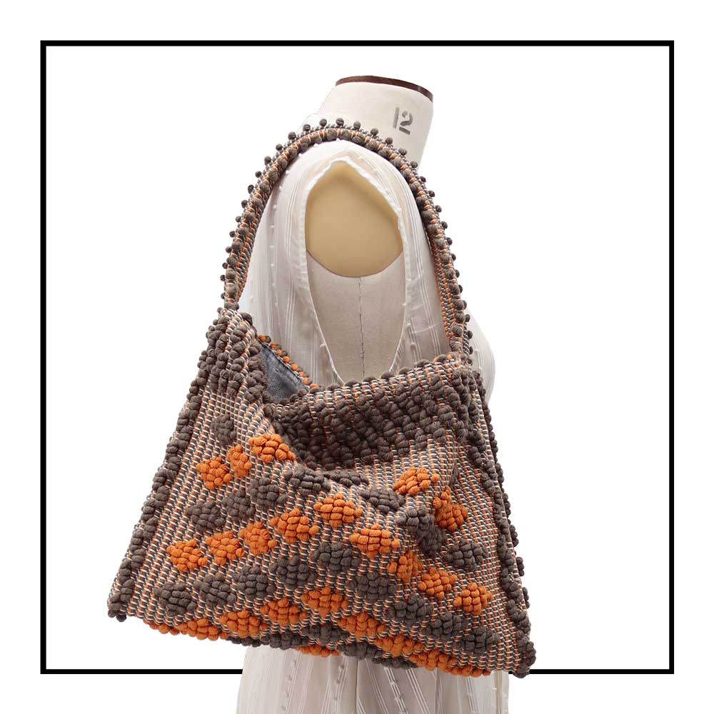 On stand, size 12 view of Quality eco-conscious hobo bag handwoven orange and taupe. Stylish clothes and Eco-Friendly with recycled yarns #luxury #ecoconcious #sustainablestyle  #ethicalbrands #ecoliving  #ecofashion #ecostyle #ethicalhandbags #handbags #sustainablelifestyle #ethicalfashion #sustainability