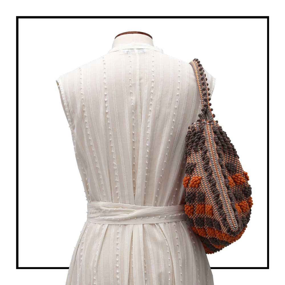 Detailed On stand, size 12, back view of Quality eco-conscious hobo bag handwoven orange and taupe. Stylish clothes and Eco-Friendly with recycled yarns #luxury #ecoconcious #sustainablestyle  #ethicalbrands #ecoliving  #ecofashion #ecostyle #ethicalhandbags #handbags #sustainablelifestyle #ethicalfashion #sustainability