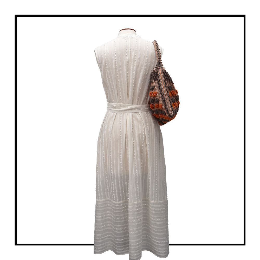 Full length On stand, back view 12 view of Quality eco-conscious hobo bag handwoven orange and taupe. Stylish clothes and Eco-Friendly with recycled yarns #luxury #ecoconcious #sustainablestyle  #ethicalbrands #ecoliving  #ecofashion #ecostyle #ethicalhandbags #handbags #sustainablelifestyle #ethicalfashion #sustainability