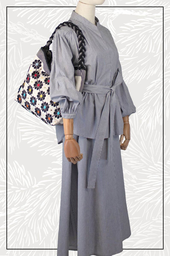 Antonello Tedde entirely hand-woven fabric shoulder bag with black flowers with colourful centre on black and white background - handmade in Sardinia, Italy