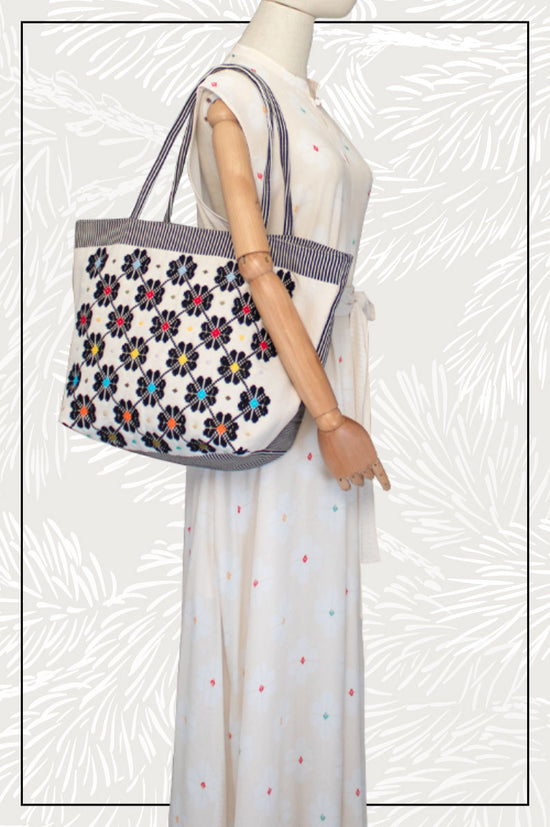 Antonello Tedde entirely hand-woven fabric tote with black flowers with colourful centre on black and white background - handmade in Sardinia, Italy  