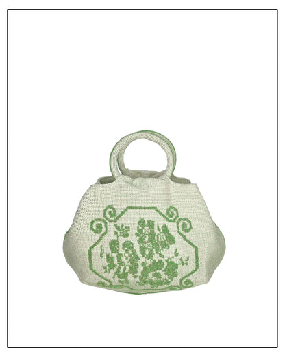 ANTONELLO TEDDE Small green handbag with a floral design on a white background. A handwoven green Faona tote bag with a small pibiones flower bouquet pattern and golden thread was crafted from regenerated cotton by Sardinian artisans.