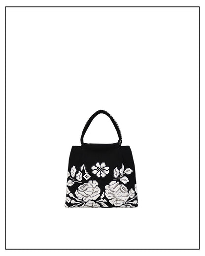 Black handbag with white floral embroidery on a white background - ANTONELLO TEDDE black and white evening bag to complete your look, with our selection of accessories crafted with the environment in mind