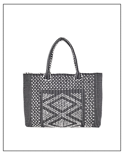Antonello Tedde's black-and-white hand-woven handbag on a white background. Front View. 