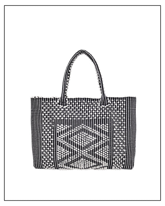 Antonello Tedde's black-and-white hand-woven handbag on a white background. Front View. 