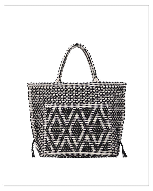 Black and white handwoven handbag with a geometric pattern on a white background by Antonello Tedde 