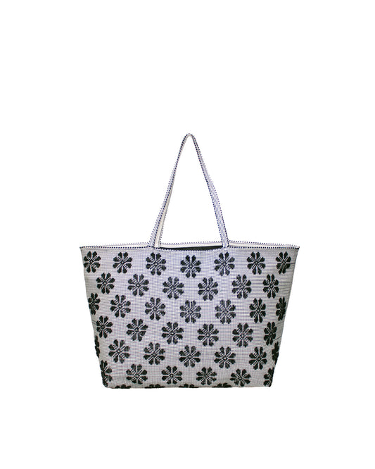 Tote bag with black floral pattern on a white background. Front view of a black and white tote bag with a daisy pattern. Main view of our Sustainable tote - summer bag - luxury handbag - handwoven made in Italy by hand  - timeless individualistic fashion • eco-friendly fashion • socially responsible, lasting fashion.