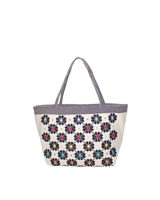 Tote bag with a floral pattern on a white background. Front view of a black and white tote bag with a daisy pattern. Main view of our Sustainable tote - summer bag - luxury handbag - handwoven made in Italy by hand  - timeless individualistic fashion • eco-friendly fashion • socially responsible, lasting fashion.