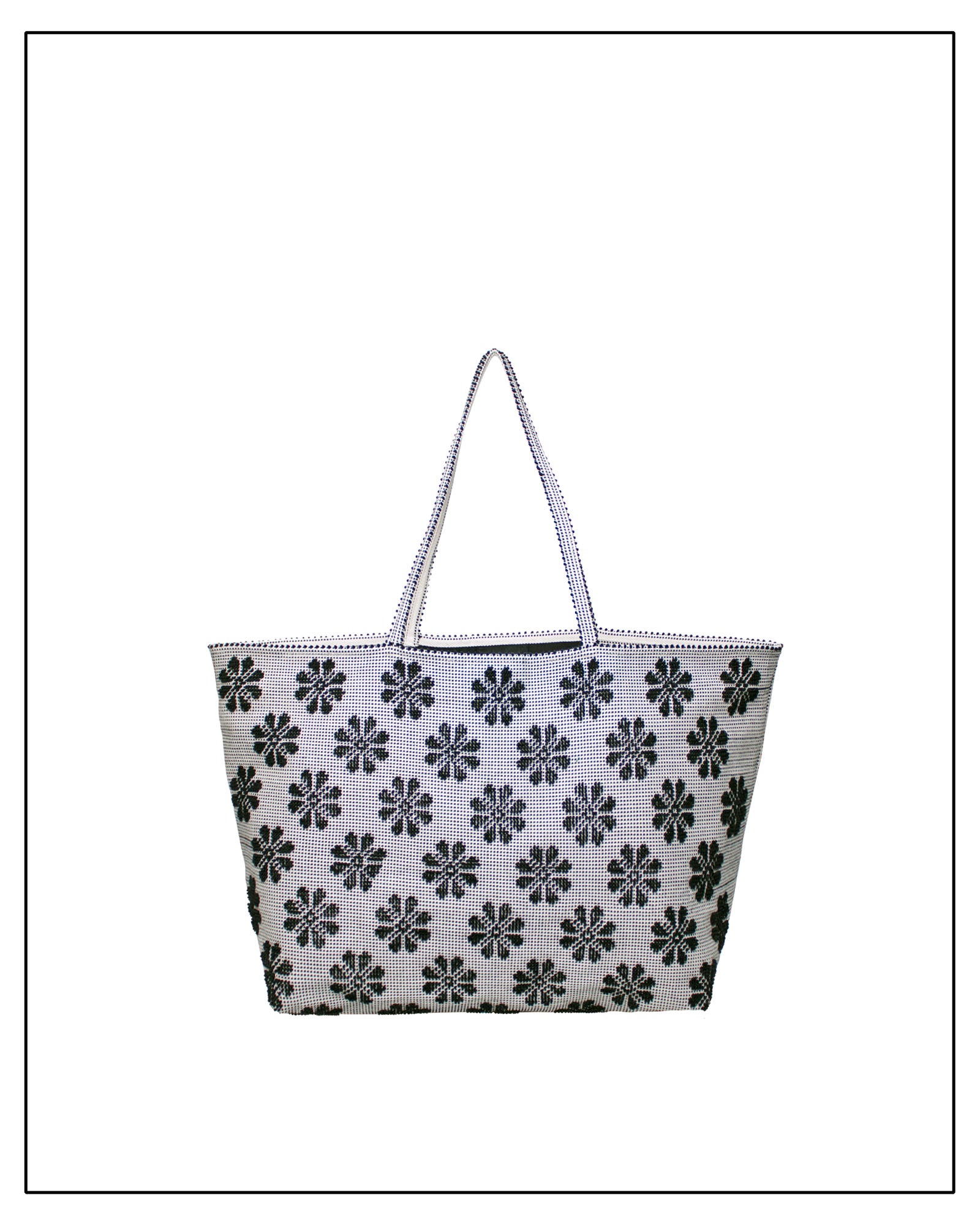 Tote bag with black floral pattern on a white background. Front view of a black and white tote bag with a daisy pattern. Main view of our Sustainable tote - summer bag - luxury handbag - handwoven made in Italy by hand  - timeless individualistic fashion • eco-friendly fashion • socially responsible, lasting fashion.