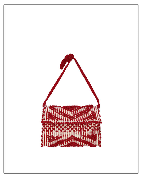 Antonello Tedde cross-body red woven clutch handbag on a white background. Exquisite collection of eco-friendly fashion accessories that embodies both luxury and uncompromising quality.