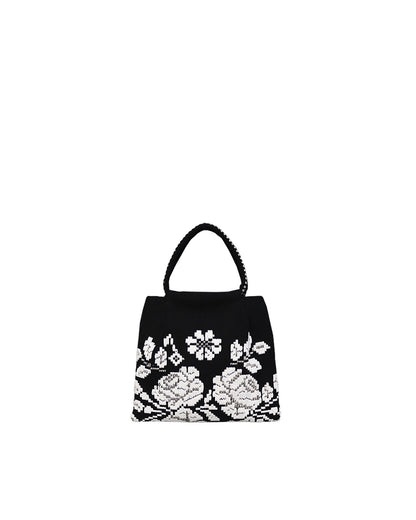 on a model with a black dress, the black and white evening bag to complete your look with our selection of accessories crafted with the environment in mind