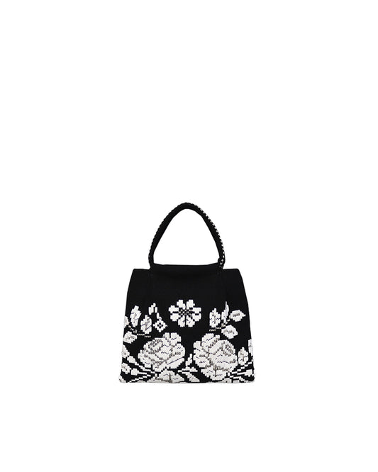 on a model with a black dress, the black and white evening bag to complete your look with our selection of accessories crafted with the environment in mind