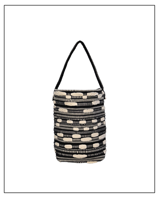 Main View of Antonello Tedde Bultei Tote Bag from the Trame in Fuga Collection, handwoven in Sardinia with black and natural cotton, textured woven motifs, and artisanal craftsmanship.