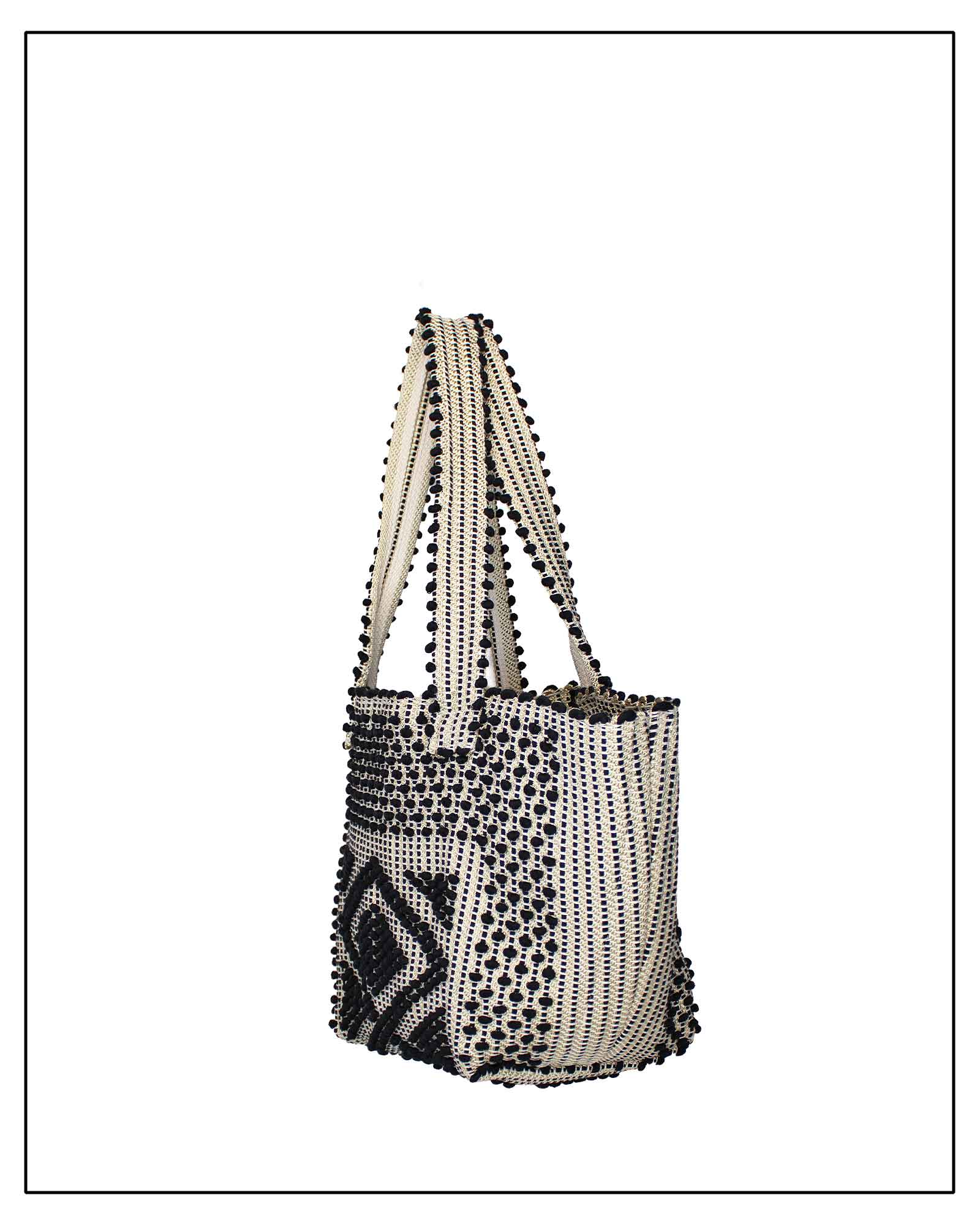 Side view of an Antonello Tedde Pula Medium Tote Bag is handwoven in Sardinia with black and golden yarn, a diamond pattern, and a practical flap pocket. 