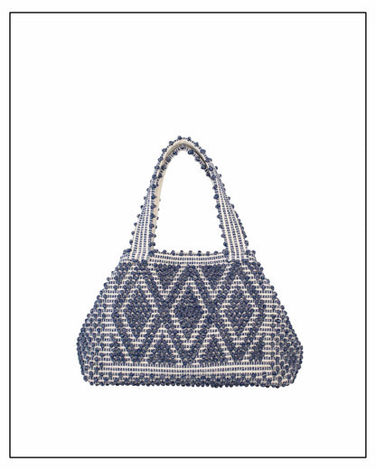 Woven handbag with blue and white pattern on a white background - Front view of Antonello Tedde Celvia Medium Tote Bag in handwoven melange blue cotton with large diamond rombi pattern