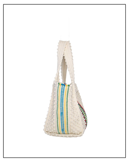 Side View of Woven handbag with colourful stripes on a white background - Pula Medium Tote Bag, a reimagined classic that marks the return of the beloved striscie (stripes) pattern in a fresh, contemporary silhouette.