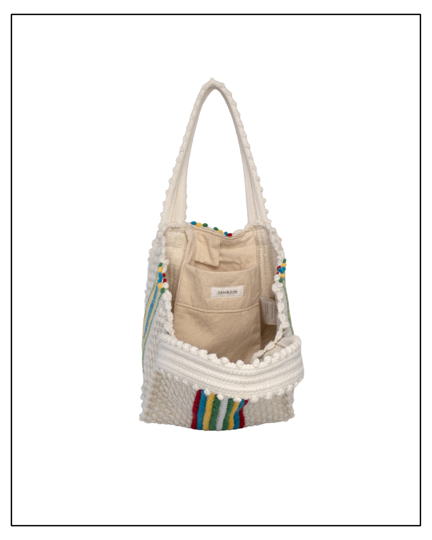 Beige bag with colourful accents inside a textured white bag on a white background.Inside view of ANTONELLO TEDDE Cream bag with colourful stripes on a white background - Pula Medium Tote Bag, a reimagined classic that marks the return of the beloved striscie (stripes) pattern in a fresh, contemporary silhouette.