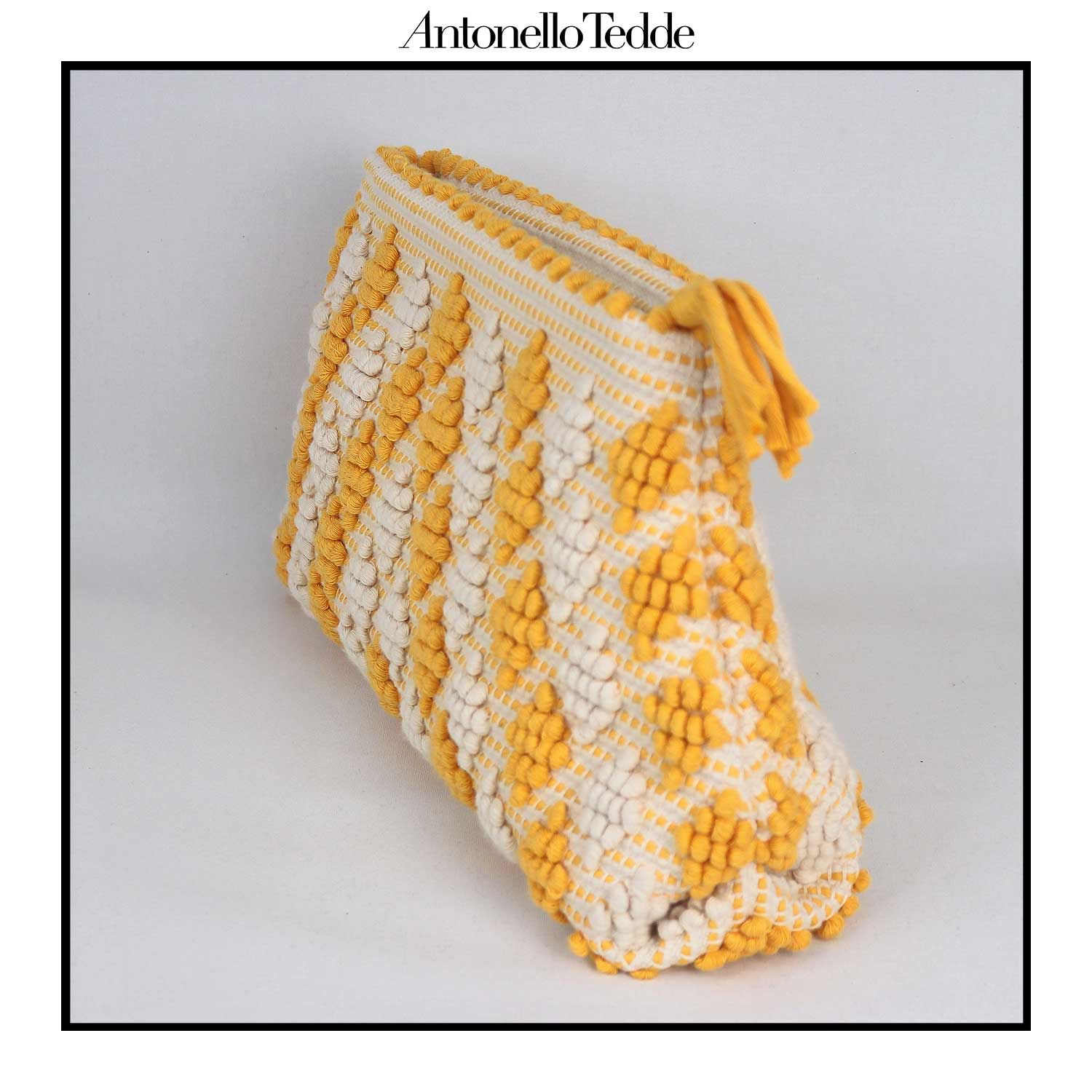 Side view of the Piatta Clutch Zip Bag, yellow and cream, sleek and sophisticated accessory designed for modern elegance. This compact clutch combines minimalist design with exceptional craftsmanship, making it a versatile companion for any occasion.