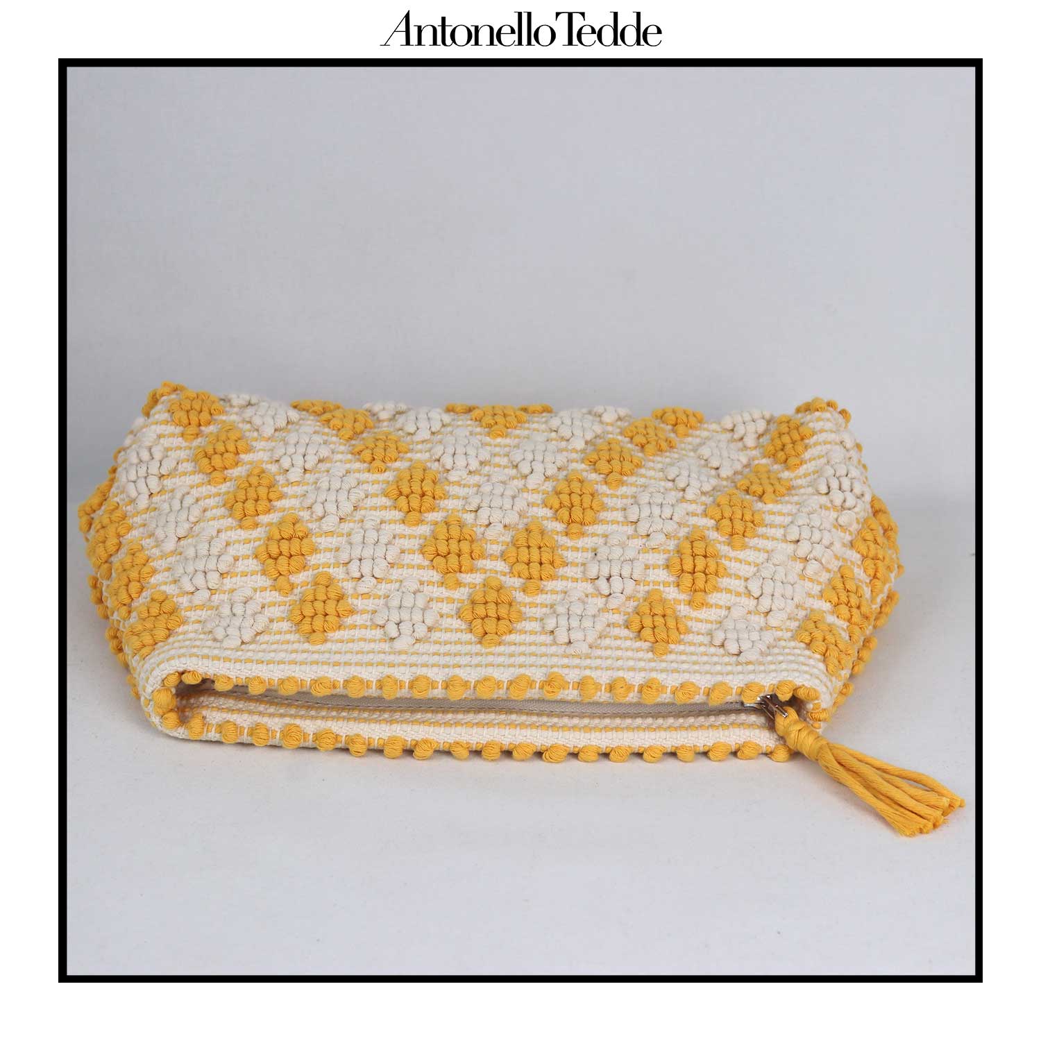 Flat view of the Piatta Clutch Zip Bag, yellow and cream, sleek and sophisticated accessory designed for modern elegance. This compact clutch combines minimalist design with exceptional craftsmanship, making it a versatile companion for any occasion.