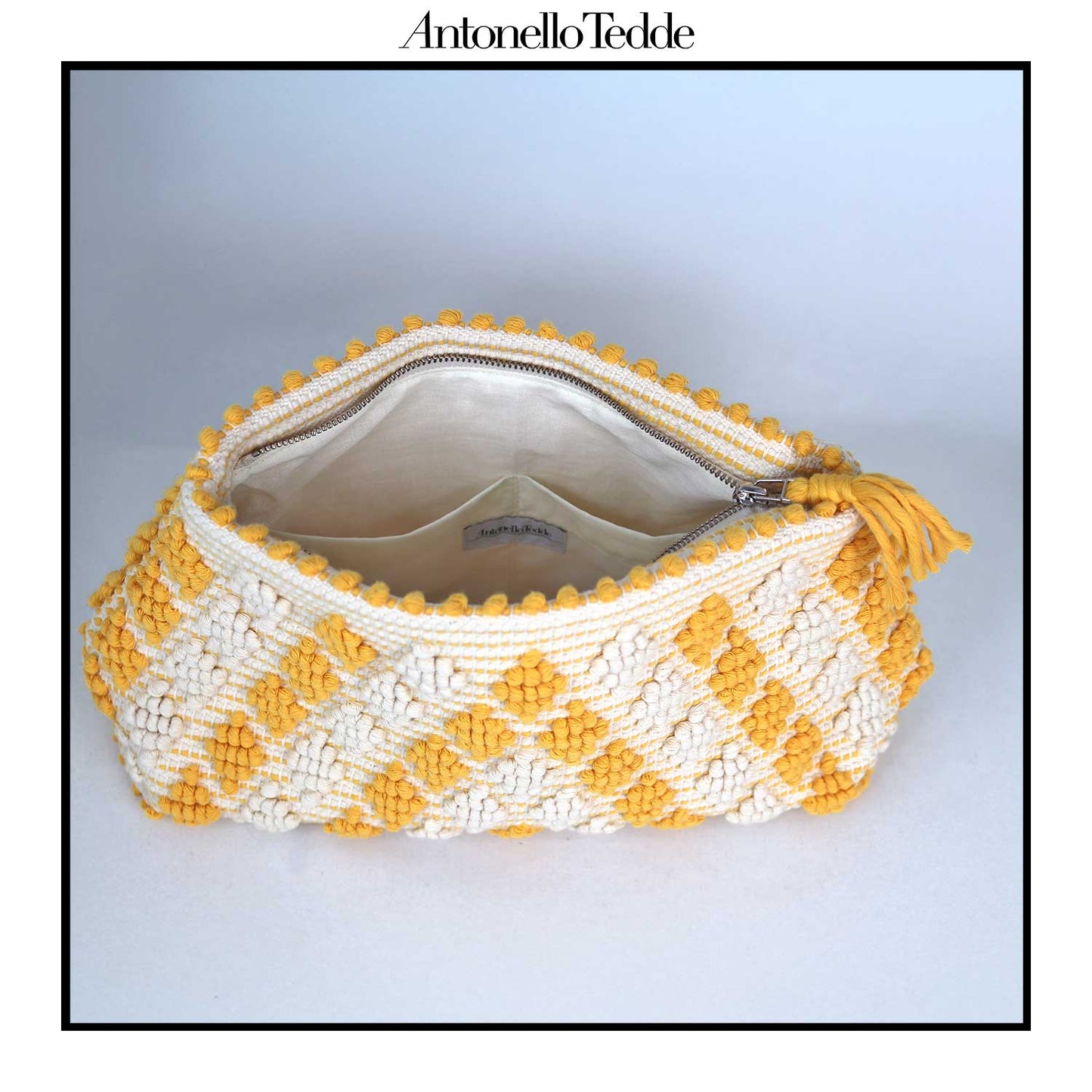Inside view of the Piatta Clutch Zip Bag, yellow and cream, sleek and sophisticated accessory designed for modern elegance. This compact clutch combines minimalist design with exceptional craftsmanship, making it a versatile companion for any occasion.