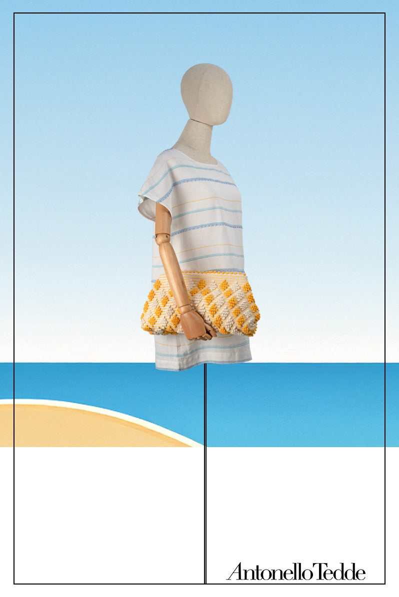 Mannequin view of the Piatta Clutch Zip Bag, yellow and cream, sleek and sophisticated accessory designed for modern elegance. This compact clutch combines minimalist design with exceptional craftsmanship, making it a versatile companion for any occasion.