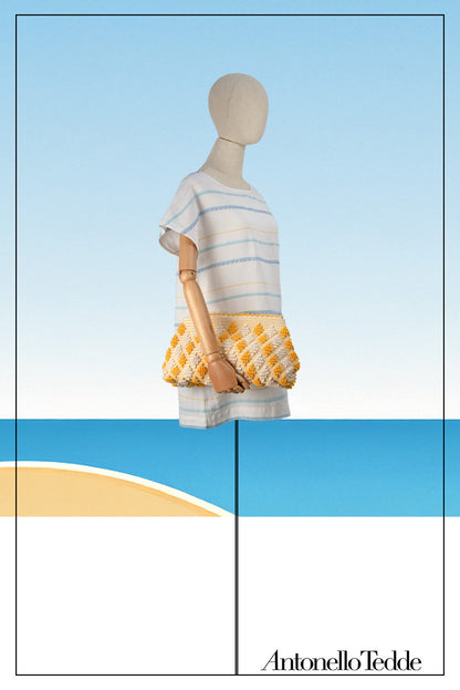 Mannequin view of the Piatta Clutch Zip Bag, yellow and cream, sleek and sophisticated accessory designed for modern elegance. This compact clutch combines minimalist design with exceptional craftsmanship, making it a versatile companion for any occasion.