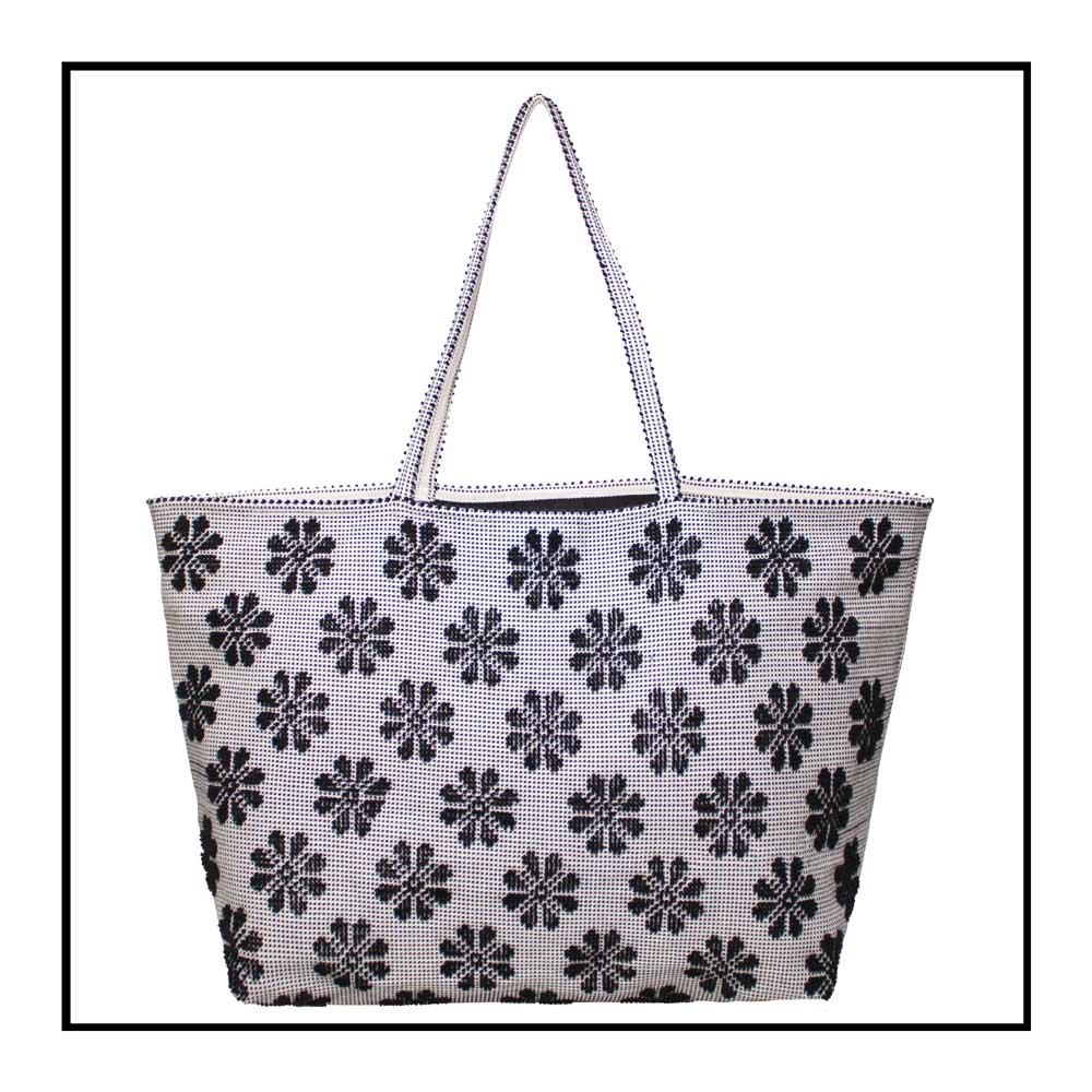 Front view of a black and white tote bag with a daisies pattern. Main view of our Sustainable tote - summer bag - luxury handbag - handwoven made in Italy by hand  - timeless individualistic fashion • eco-friendly fashion • socially responsible, lasting fashion.