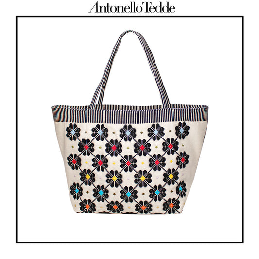 Front view of a black and white tote bag with a daisy pattern. Main view of our Sustainable tote - summer bag - luxury handbag - handwoven made in Italy by hand  - timeless individualistic fashion • eco-friendly fashion • socially responsible, lasting fashion.
