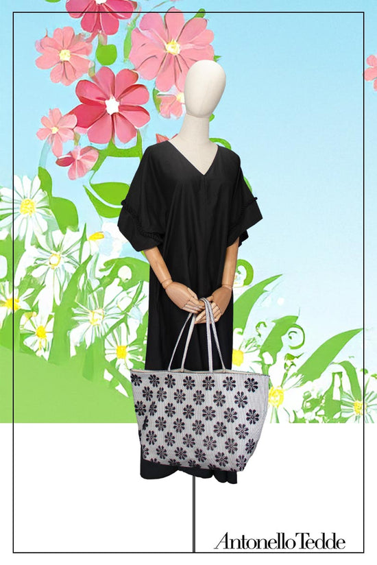 Main view of a black and white tote bag with a daisies pattern. Main view of our Sustainable tote - summer bag - luxury handbag - handwoven made in Italy by hand  - timeless individualistic fashion • eco-friendly fashion • socially responsible, lasting fashion.