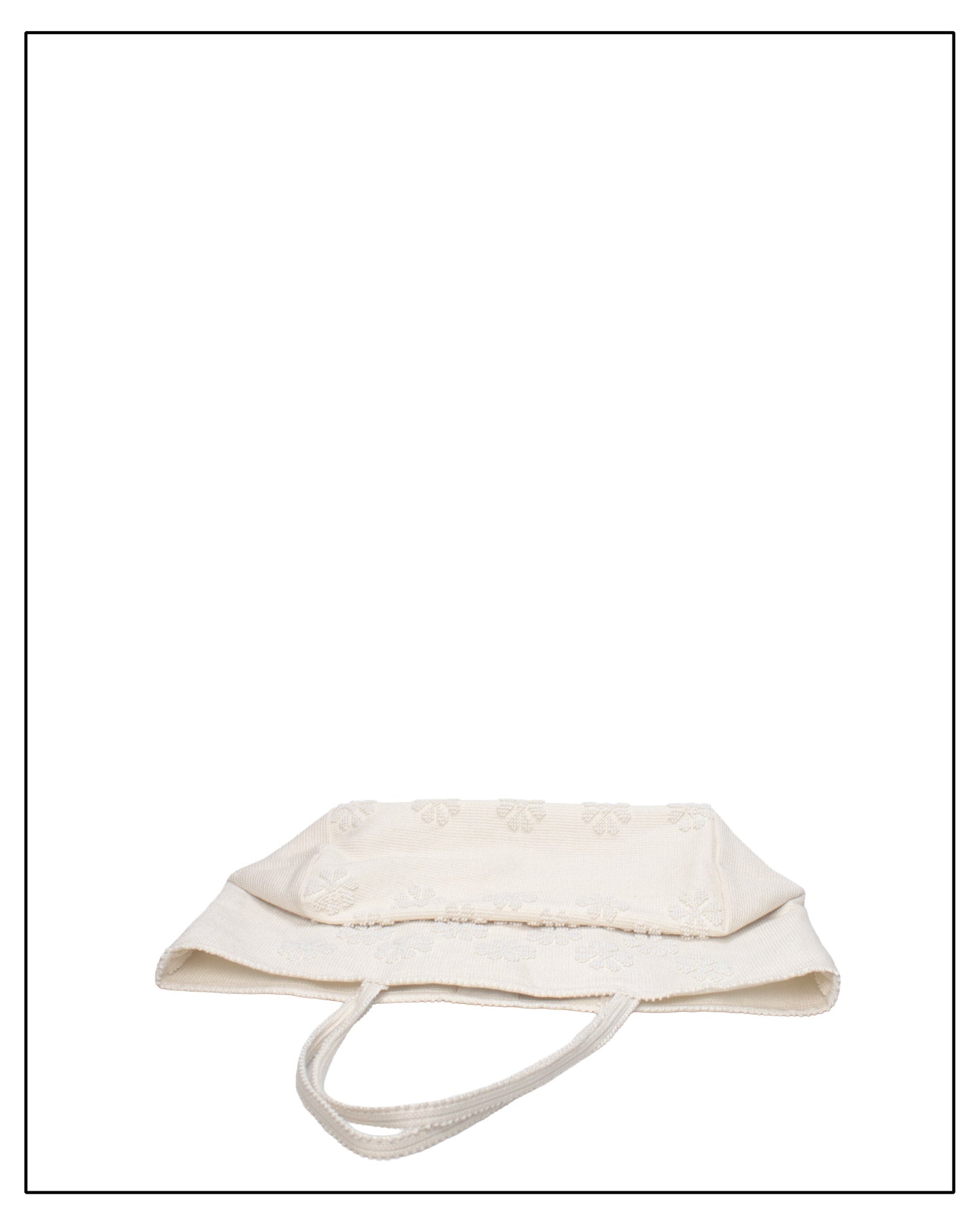 Folded view of Raised flower pattern handwoven cream tote bag, all by Antonello Tedde