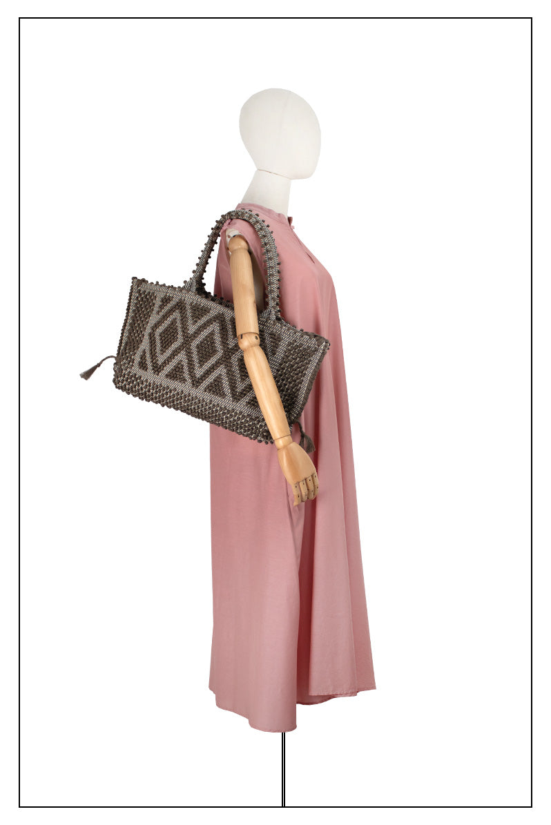 The handbag on a model with dark pink dress is a brown linen Sustainable tote - summer bag - luxury handbag - handwoven black and white tote made in Italy by hand • timeless individualistic fashion • eco-friendly fashion • socially responsible, lasting fashion