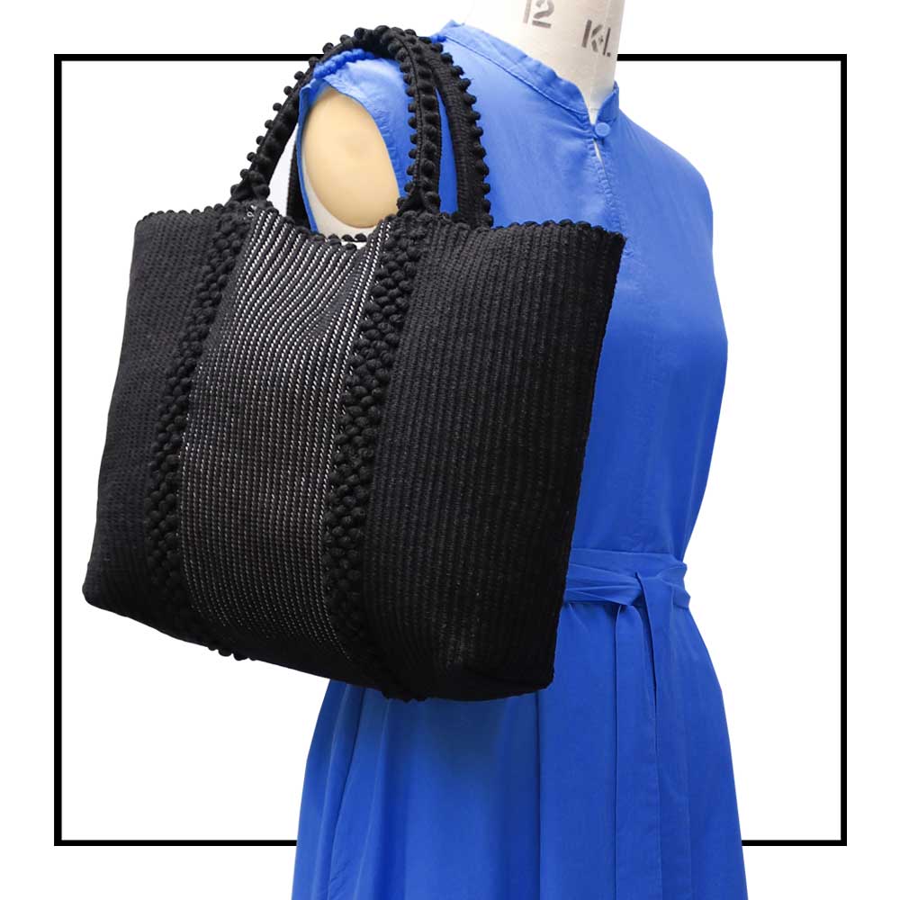 LISCIA Tro - Green and Black -tote-handbag- on mannequin with blue dress close up -eco-friendly-fashion-handbag-preserving-craft