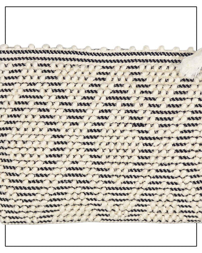 Antonello Tedde Hand-woven clutch bag with black and white pattern on a white background - detail view