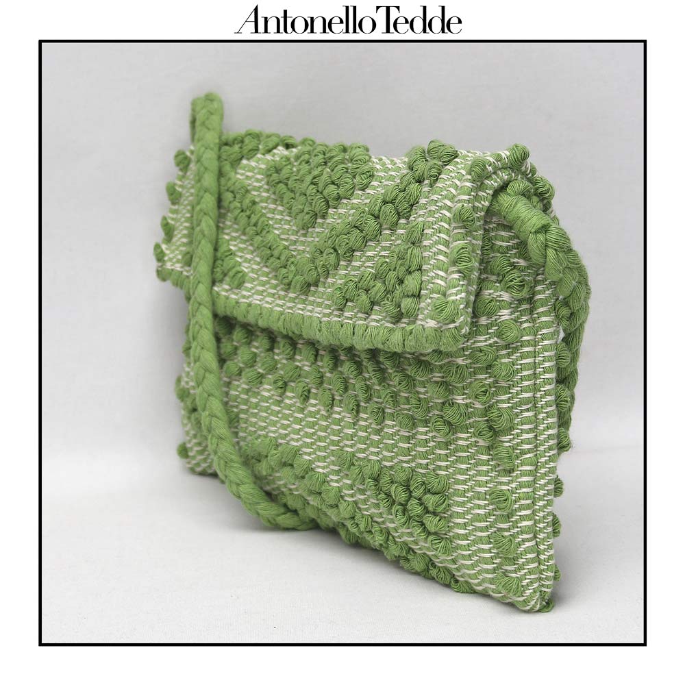 Side view of the green ground beloved style within the Antonello Tedde collection, the Suni Rombi Clutch cross-body.   The bag is celebrated for its effortless blend of elegance, function, and sustainable craftsmanship.